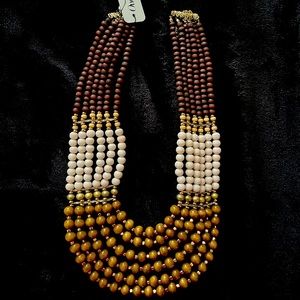 Brown, tan and beige necklace. Create a dramatic look with this bold necklace.